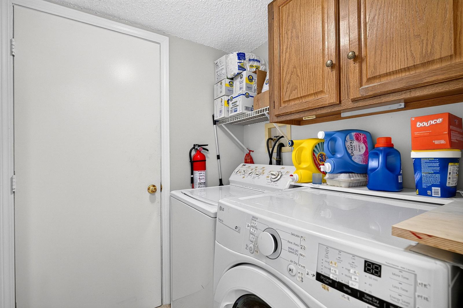 First-floor laundry room with cabinets; washer and dryer stay with the home